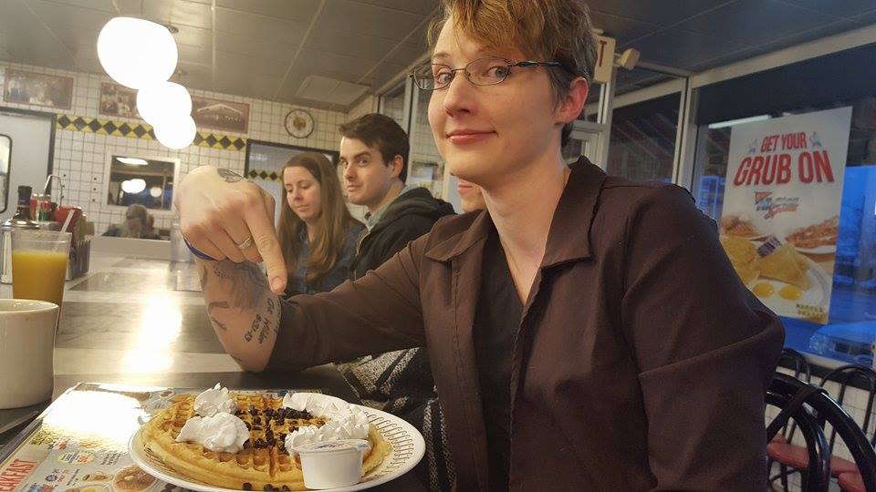 a woman pointing at a waffle